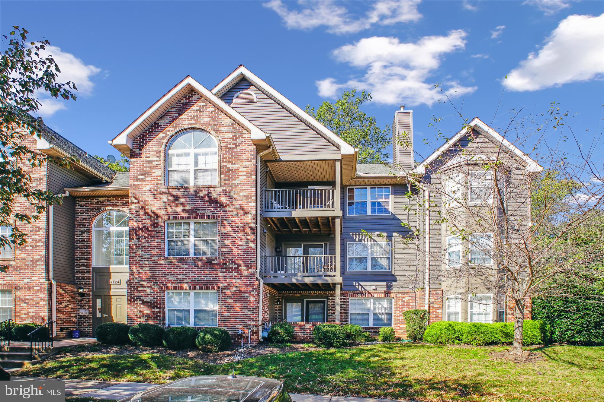 a front view of a residential apartment building with a yard