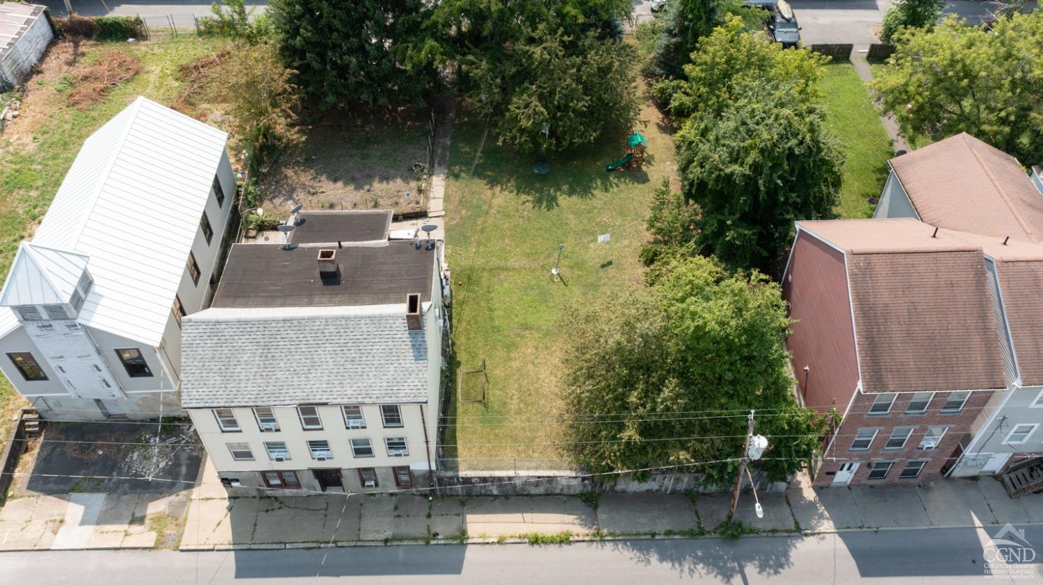 an aerial view of a house with a yard