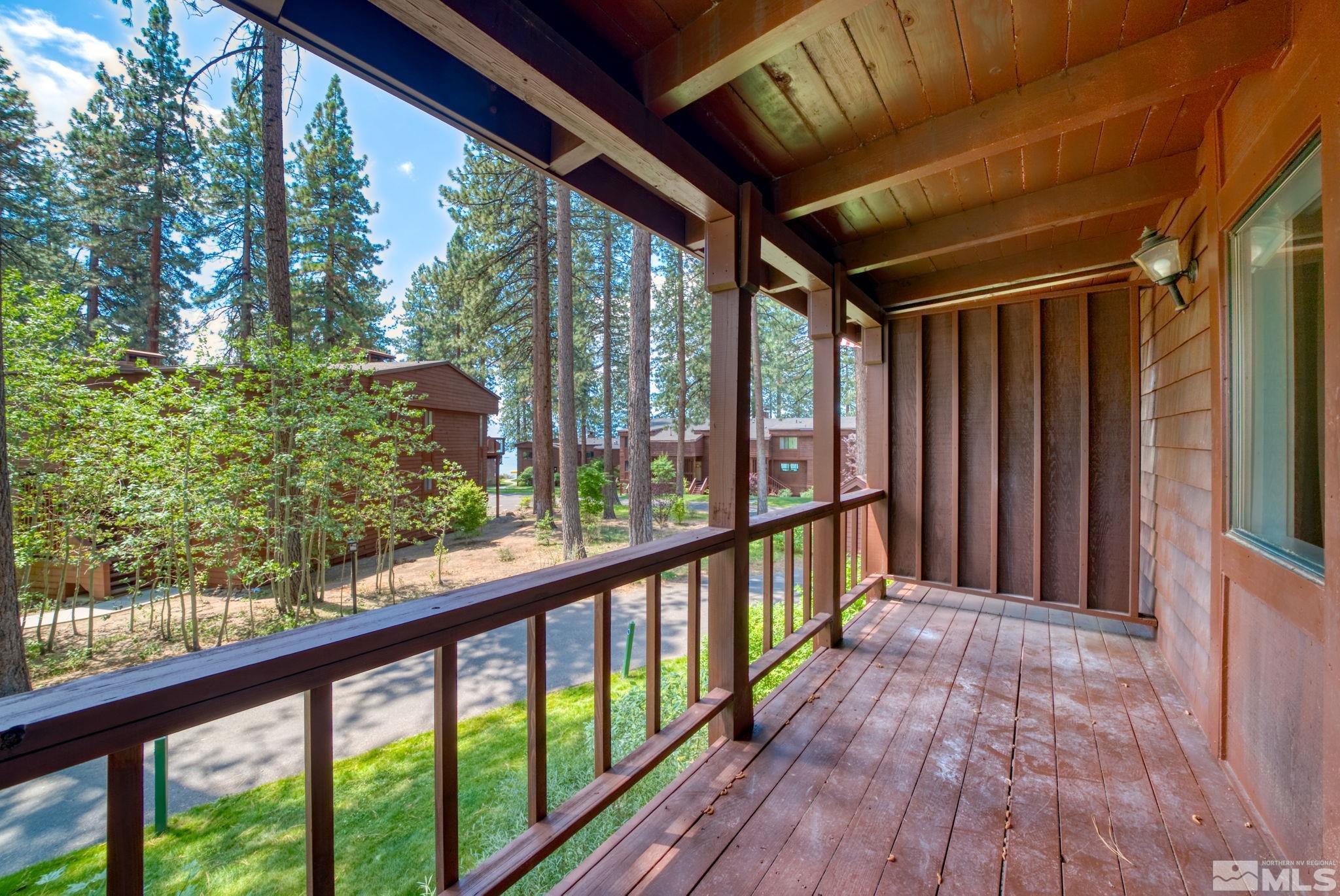 a view of a porch with wooden floor and outdoor space