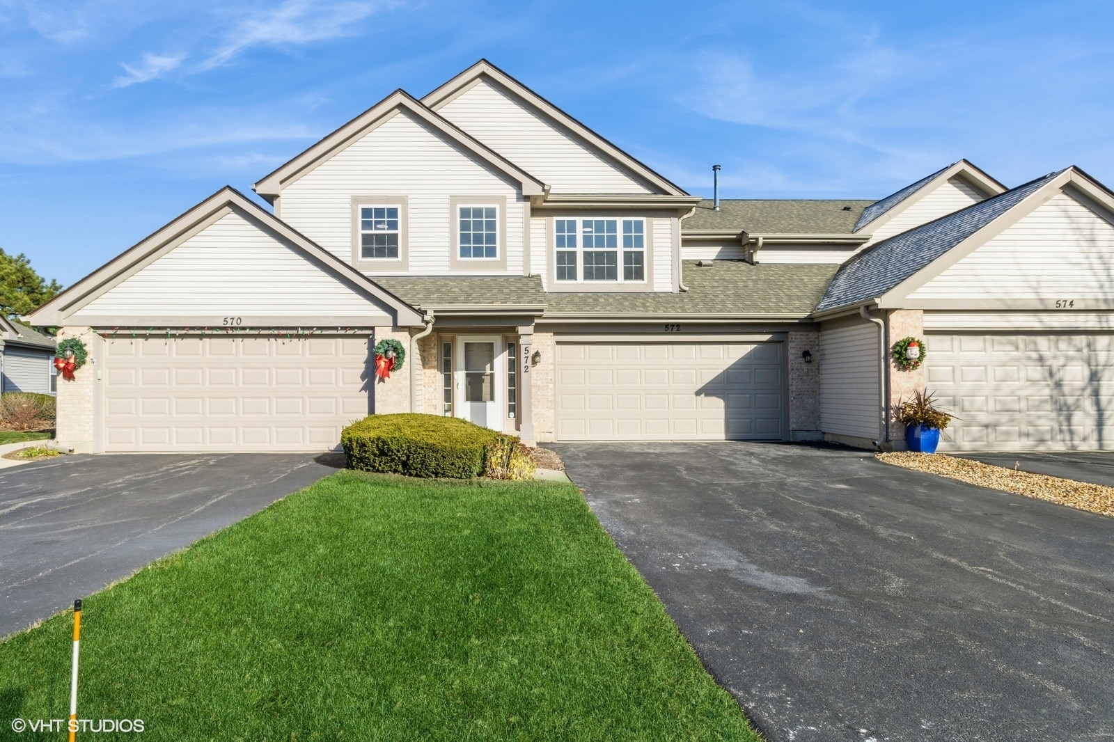 a view of a house with a yard and garage