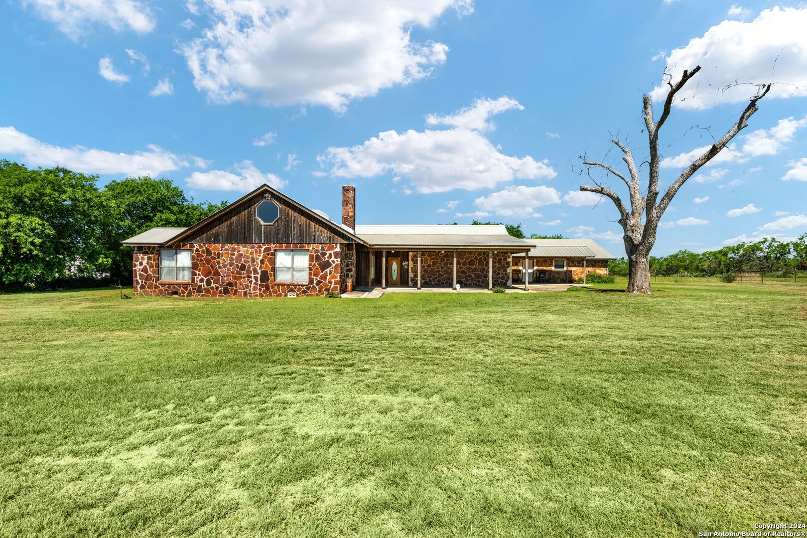 a front view of house with yard and green space