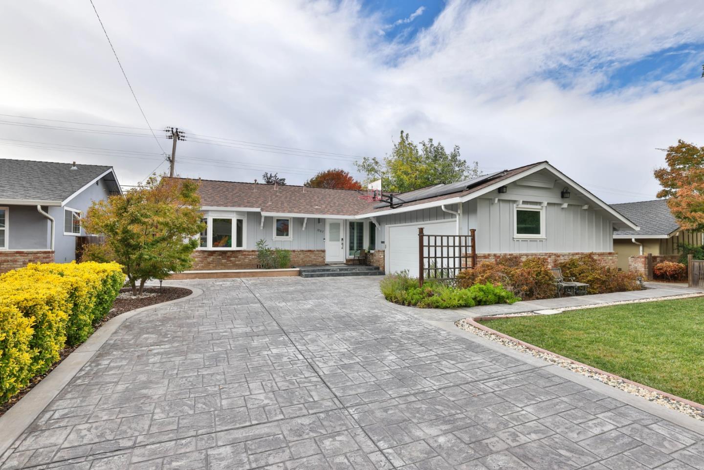 a front view of house with yard and green space