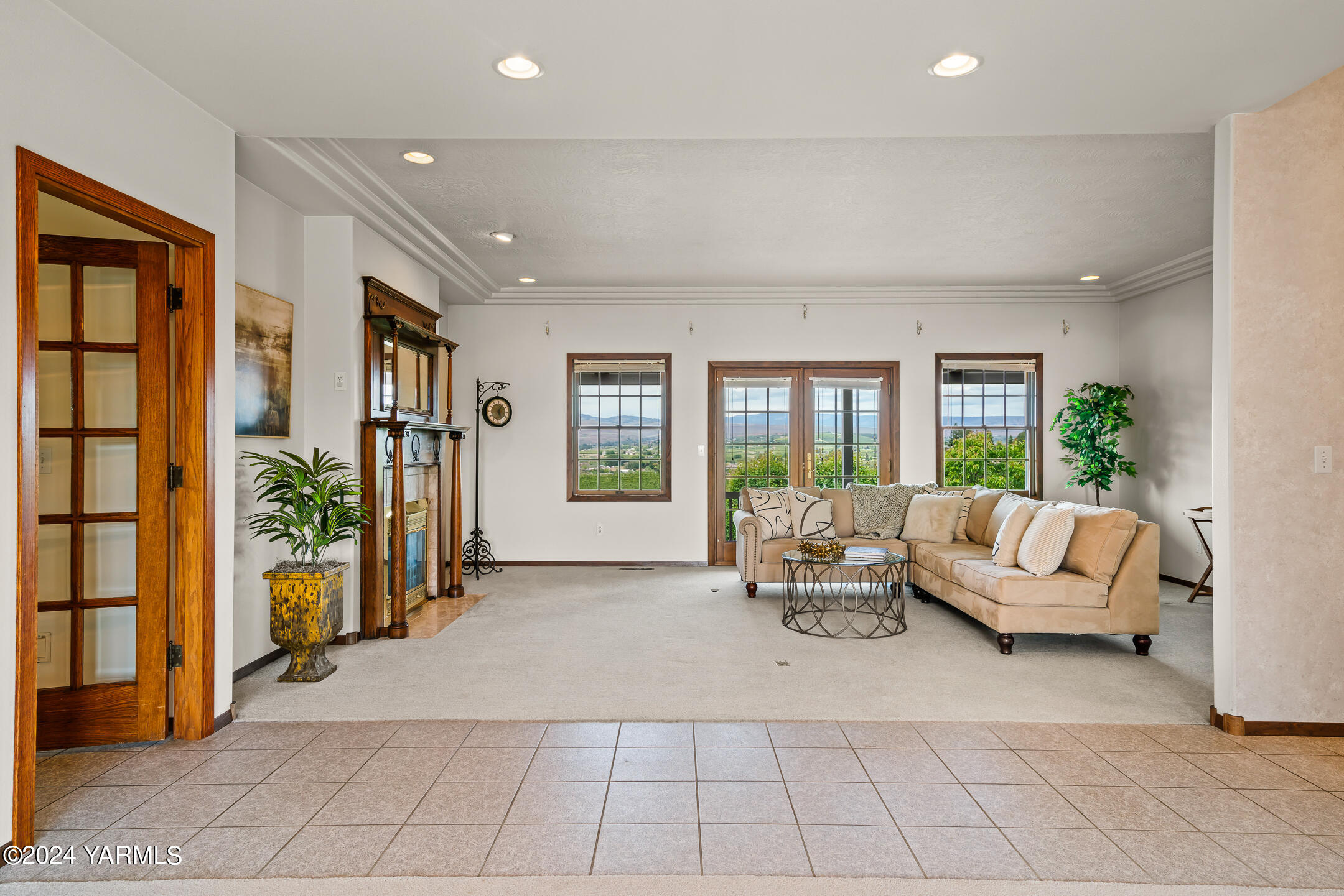 a living room with furniture and large windows