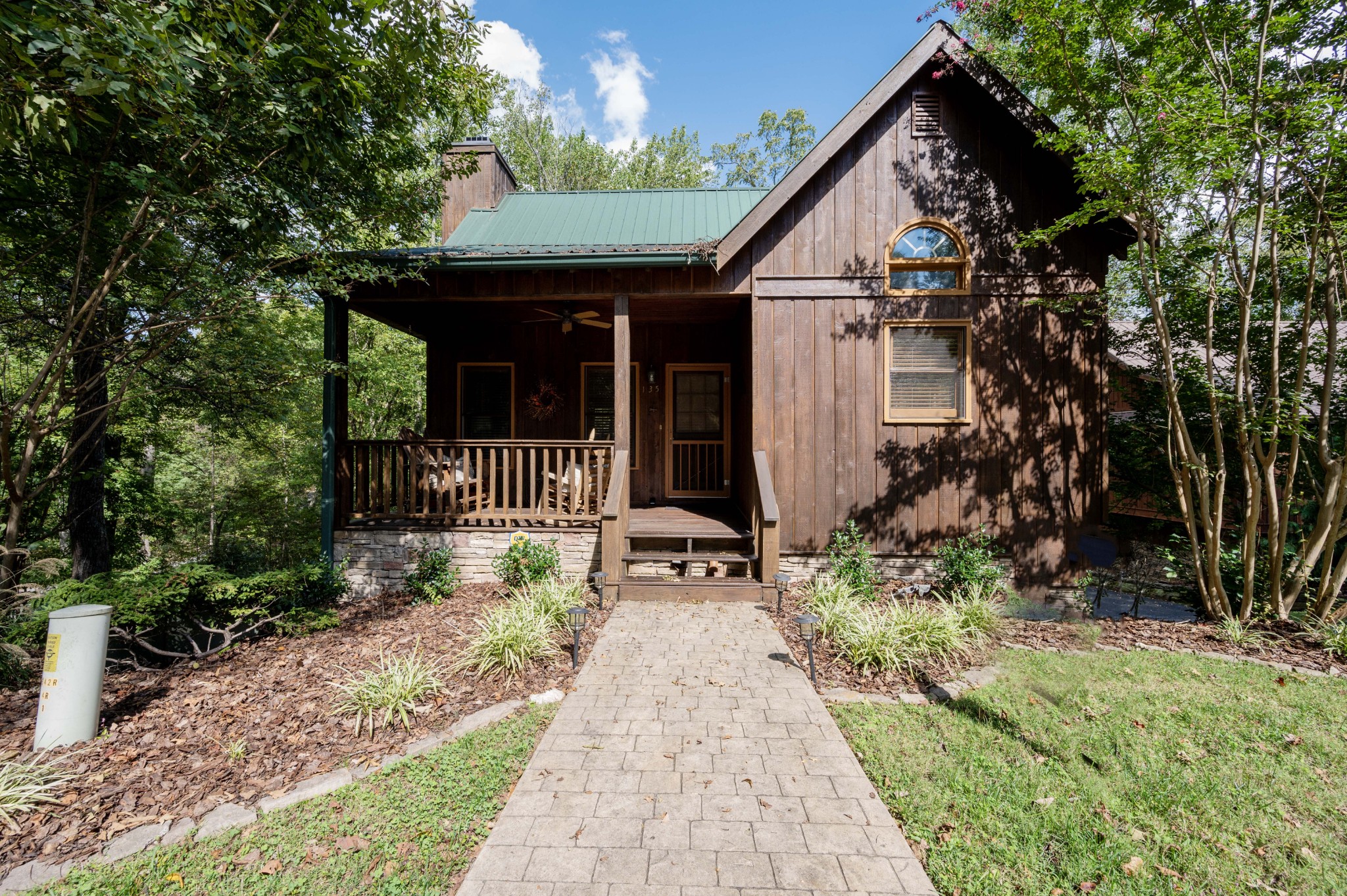 a front view of a house with a garden