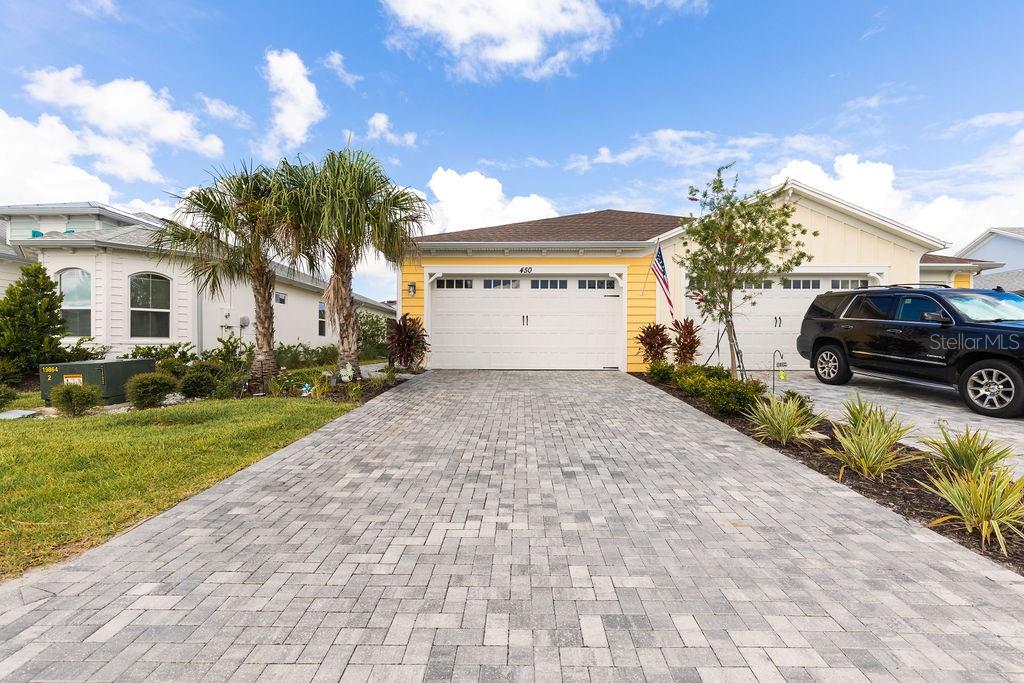 a front view of a house with a yard and a garage