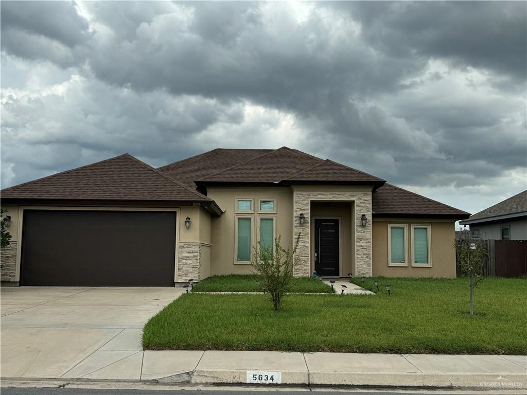 a front view of a house with a yard and garage