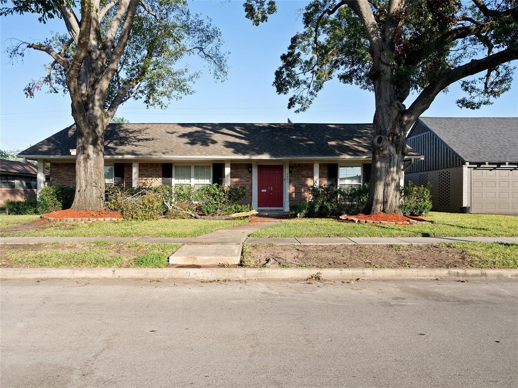 front view of a house with a tree in front of it