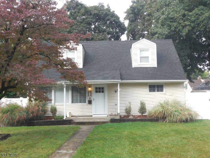 a front view of a house with a garden and yard