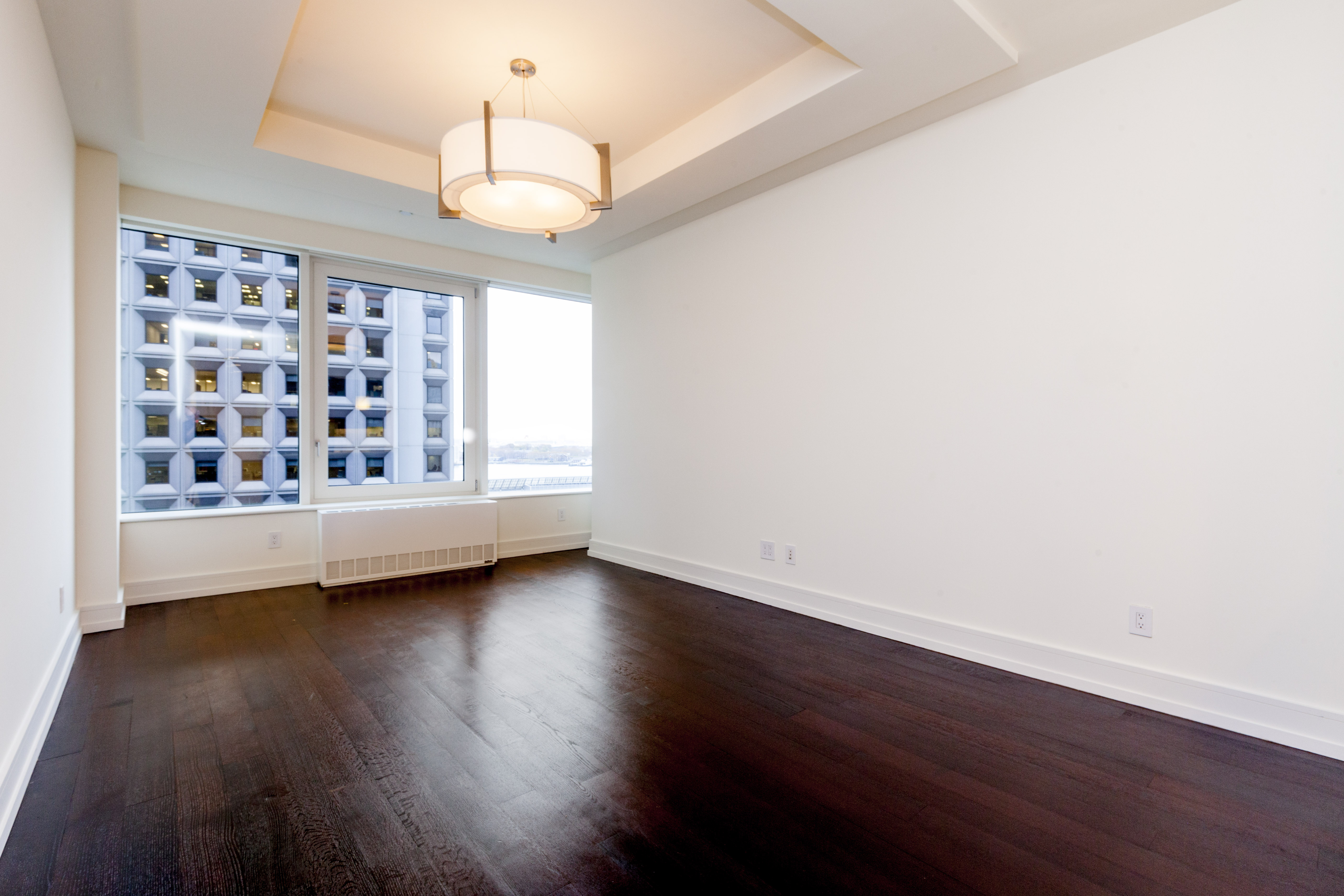 a view of wooden floor and windows in a room