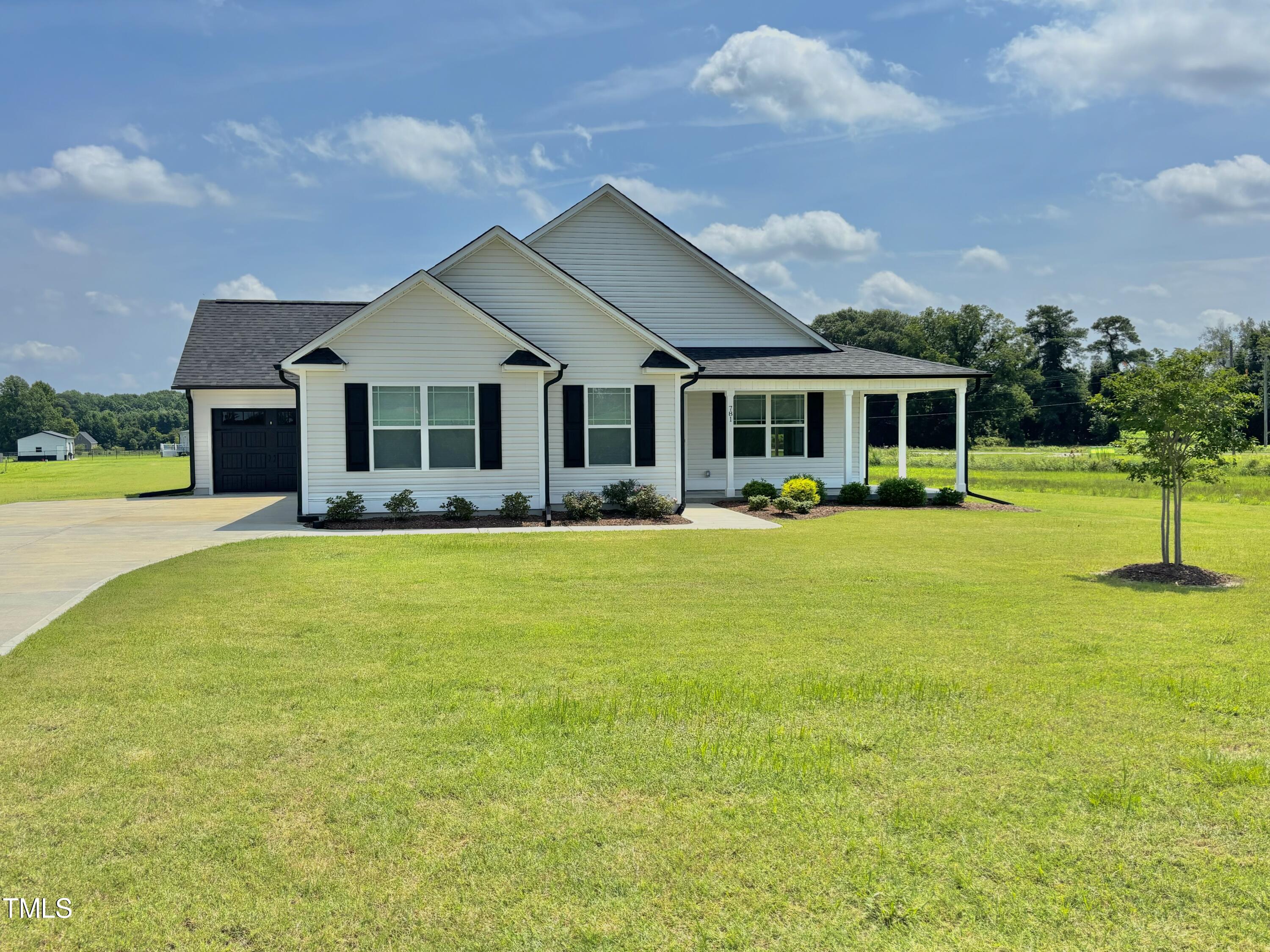 a front view of house with yard and outdoor seating