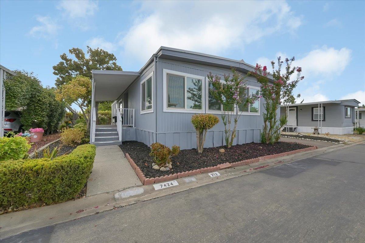 a front view of a house with a yard and outdoor seating