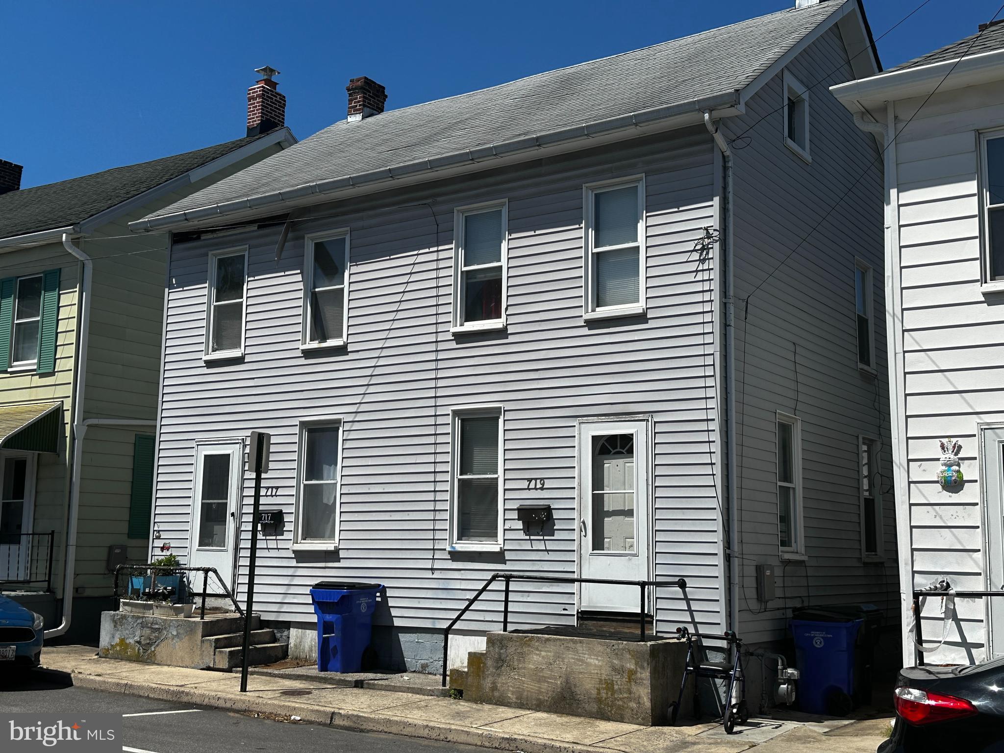 a front view of a house with a street