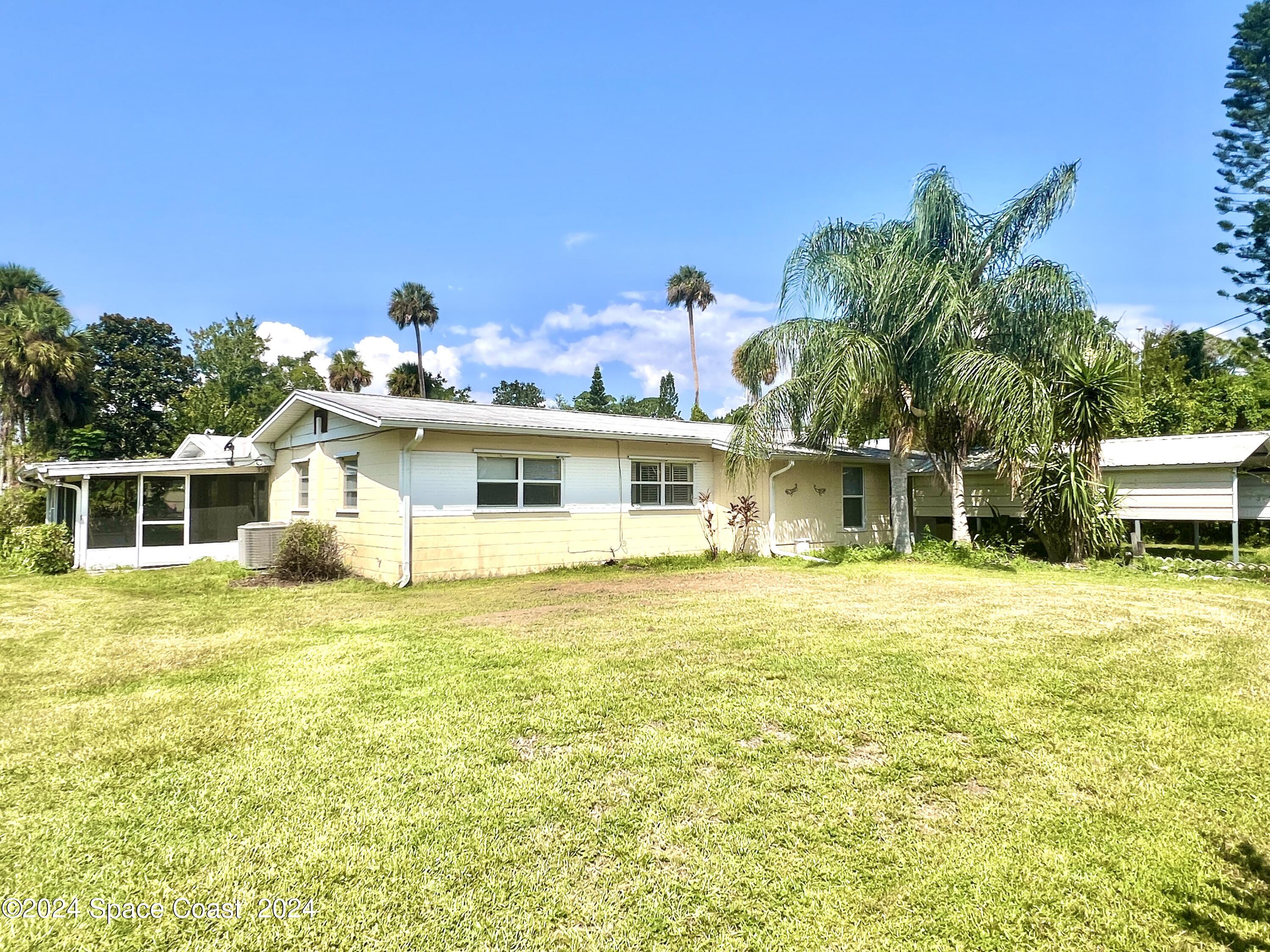 a front view of a house with a big yard