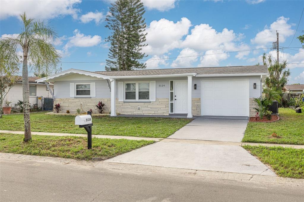 a front view of house with yard and green space