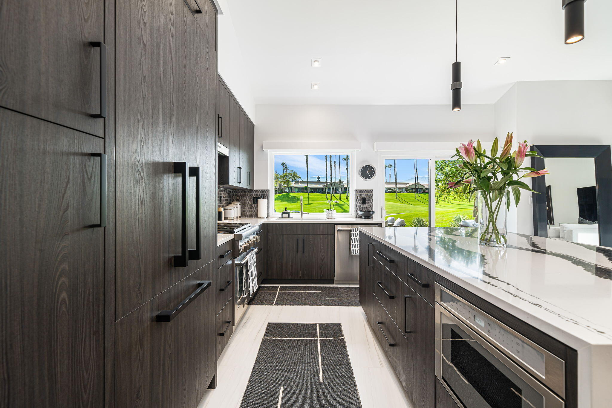 a kitchen with stainless steel appliances a sink and a refrigerator