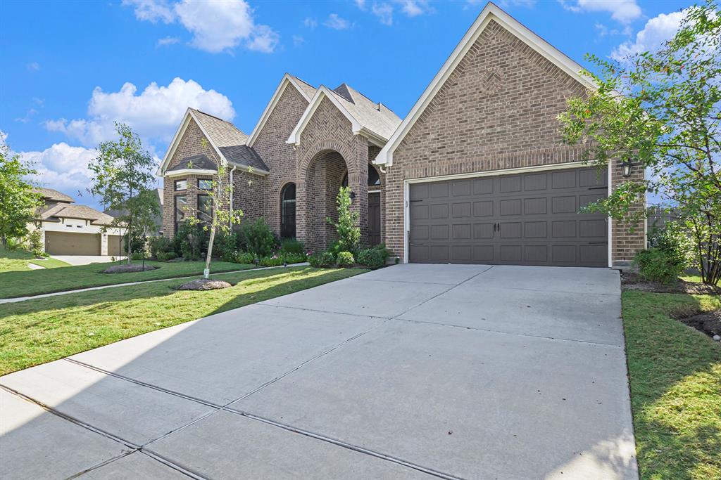 a front view of a house with yard and a garage