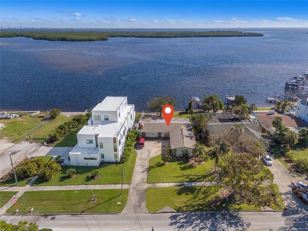 an aerial view of a house with a yard basket ball court and outdoor seating