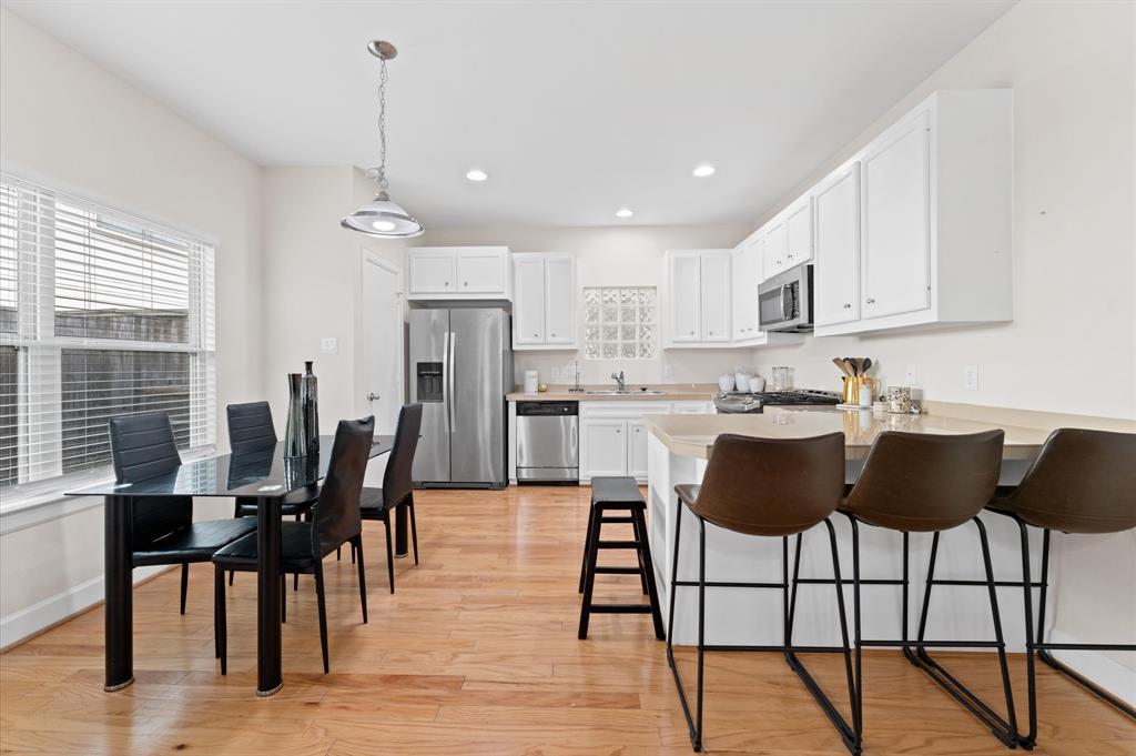 a view of kitchen with cabinets and dining table