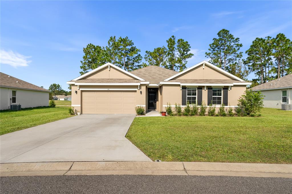 a front view of a house with a yard