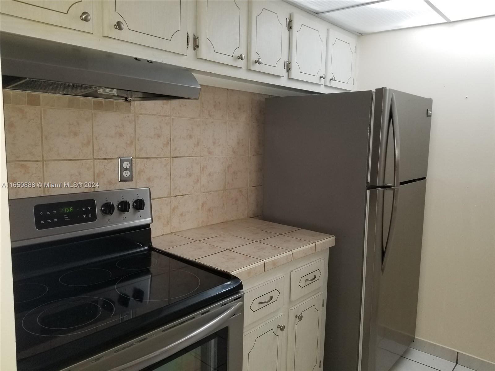 a kitchen with appliances and cabinets