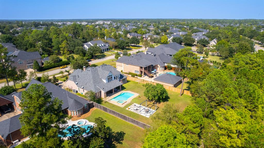 an aerial view of residential house with outdoor space and swimming pool