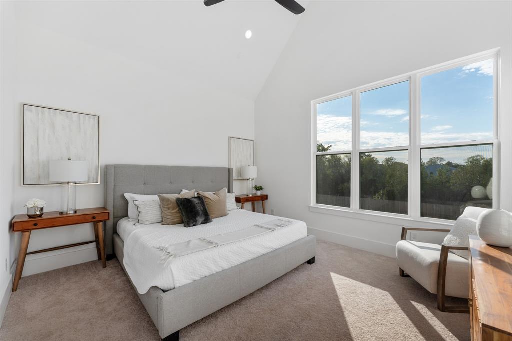 a bedroom with bed and glass window