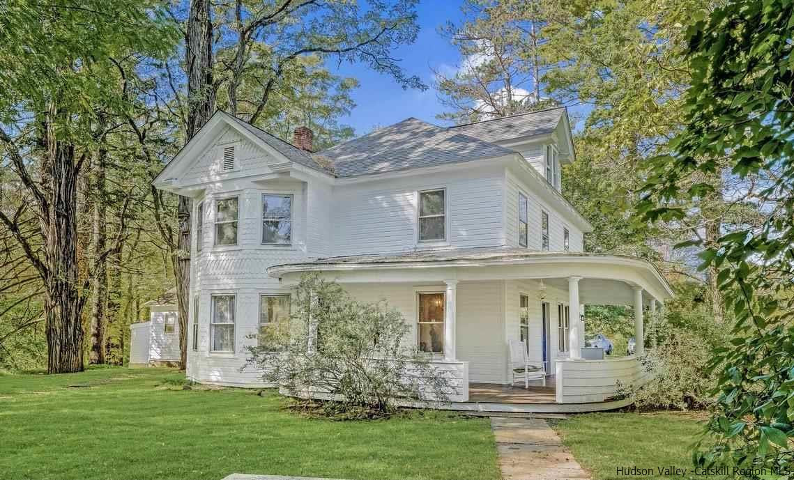 a front view of a house with a garden