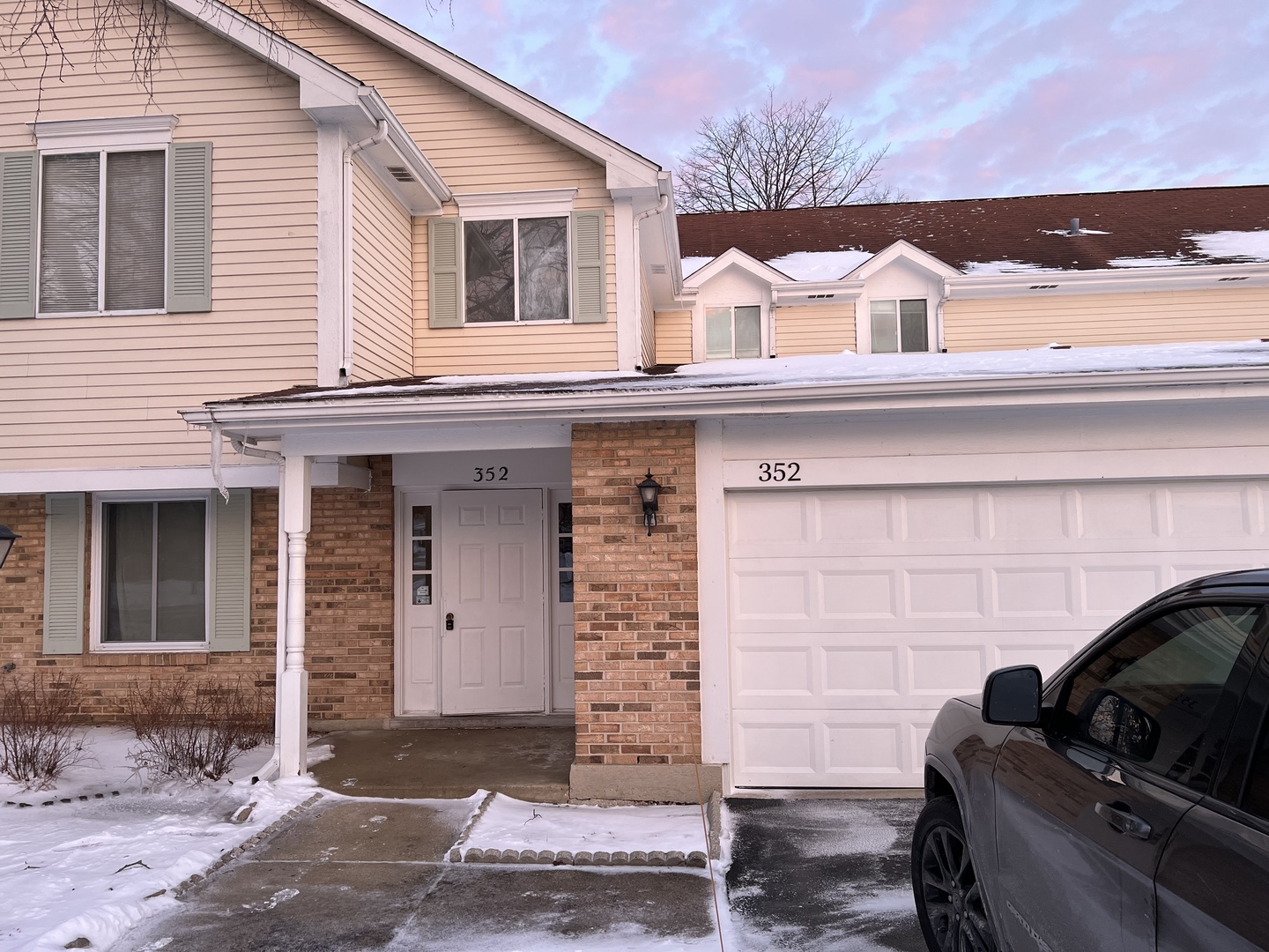 a front view of a house with parking space