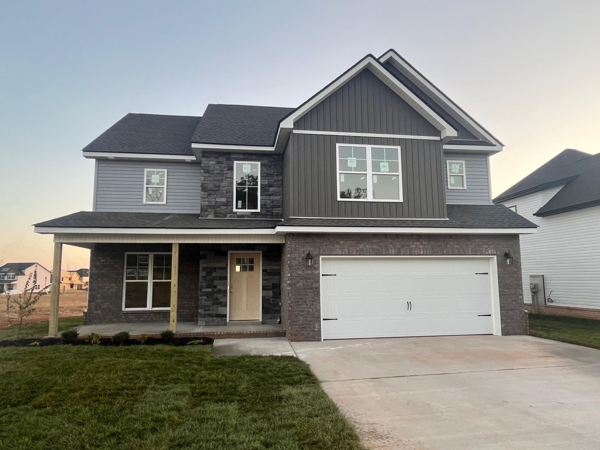 a front view of a house with a yard and garage