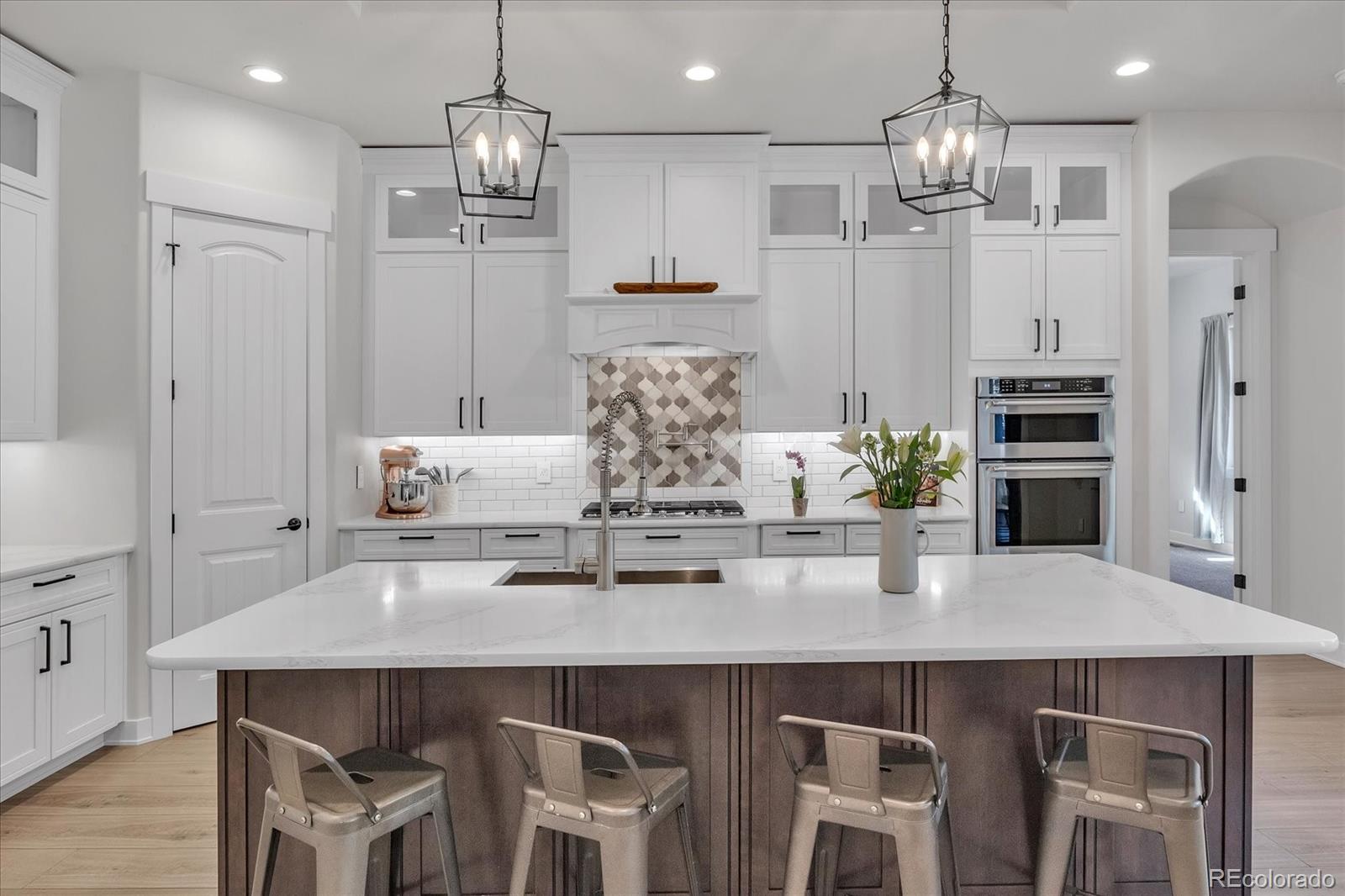 a kitchen with stainless steel appliances kitchen island granite countertop a table and chairs in it