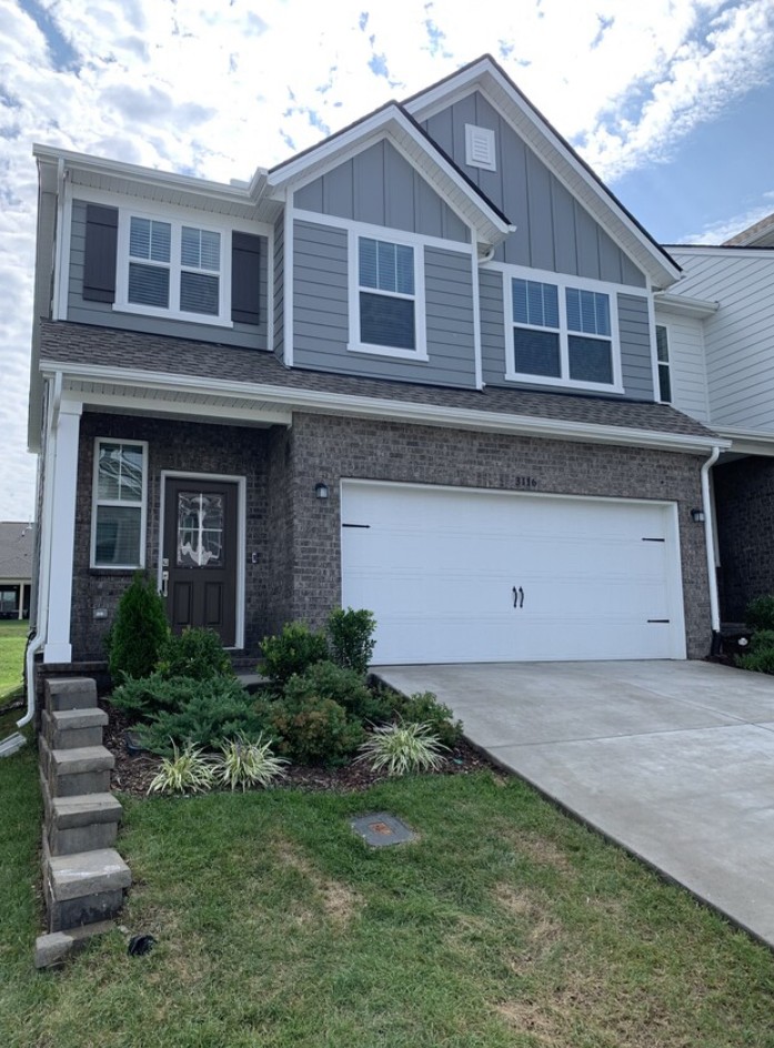 a front view of a house with a yard and garage