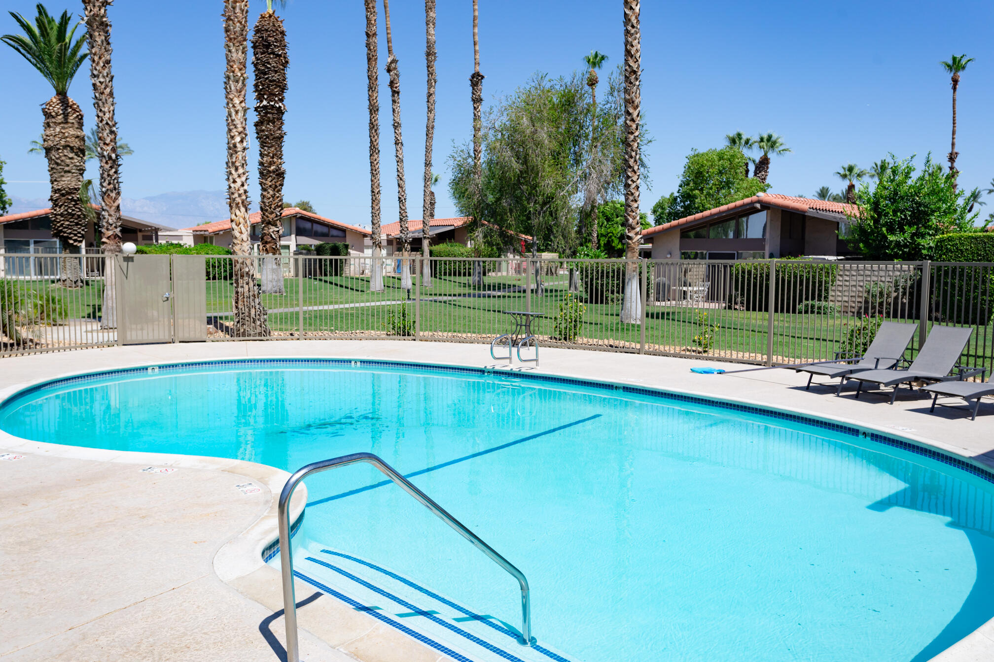 a view of a swimming pool and lounge chairs