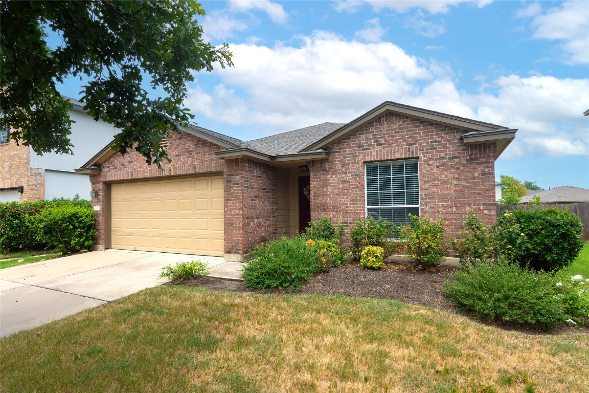 a front view of house with yard and trees around