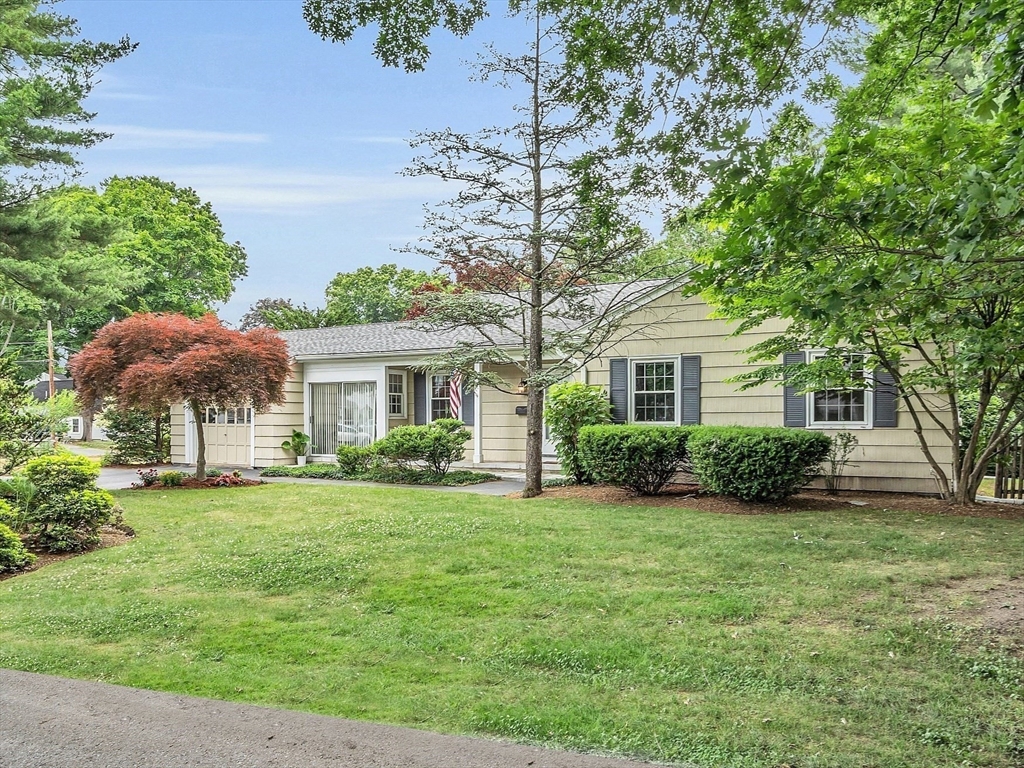 a front view of a house with a garden