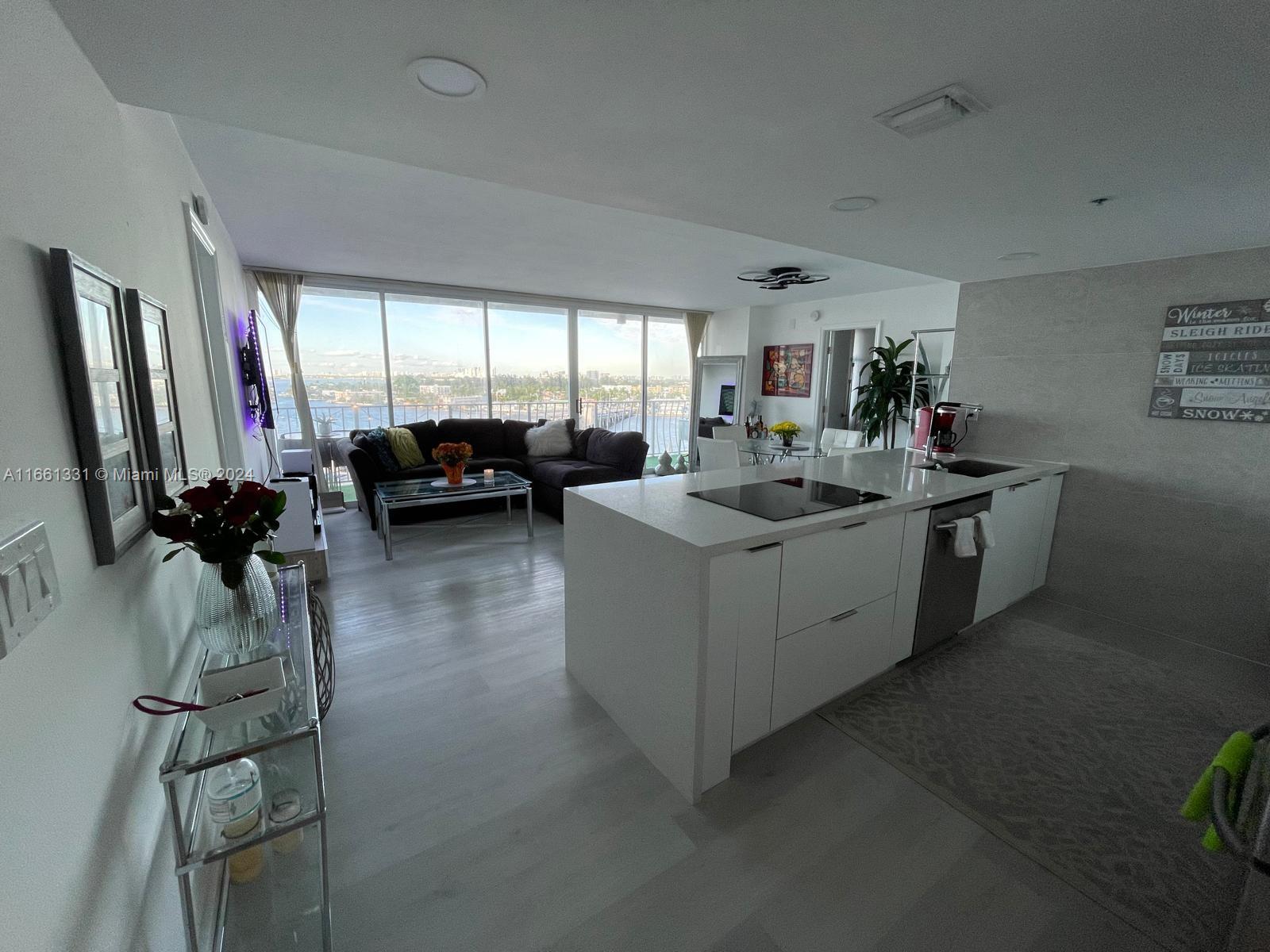 a living room with furniture a window and gym equipment