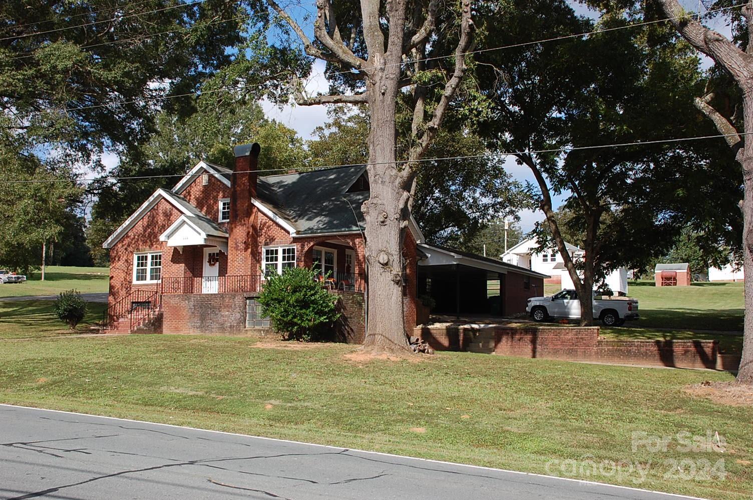 a front view of house with yard and trees