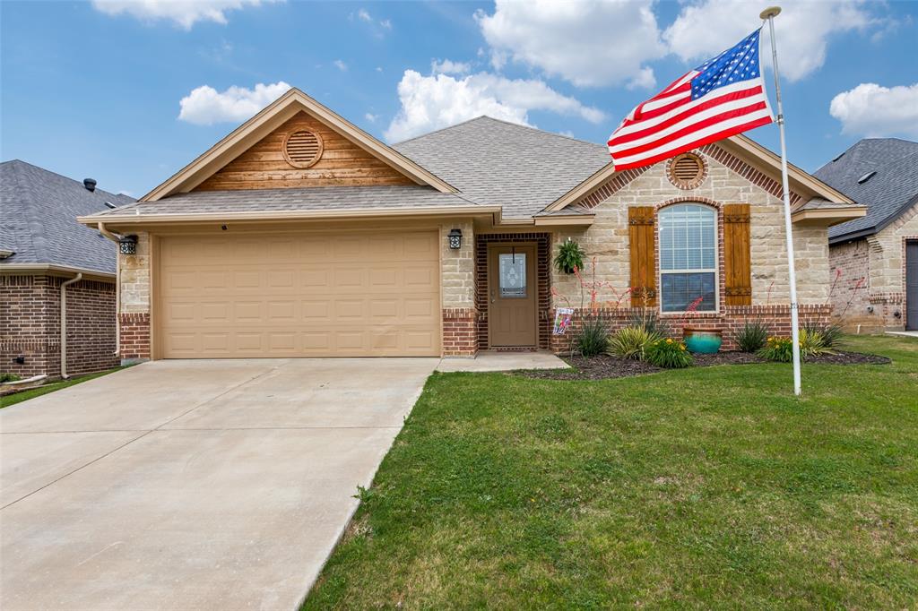 a front view of a house with a yard and garage