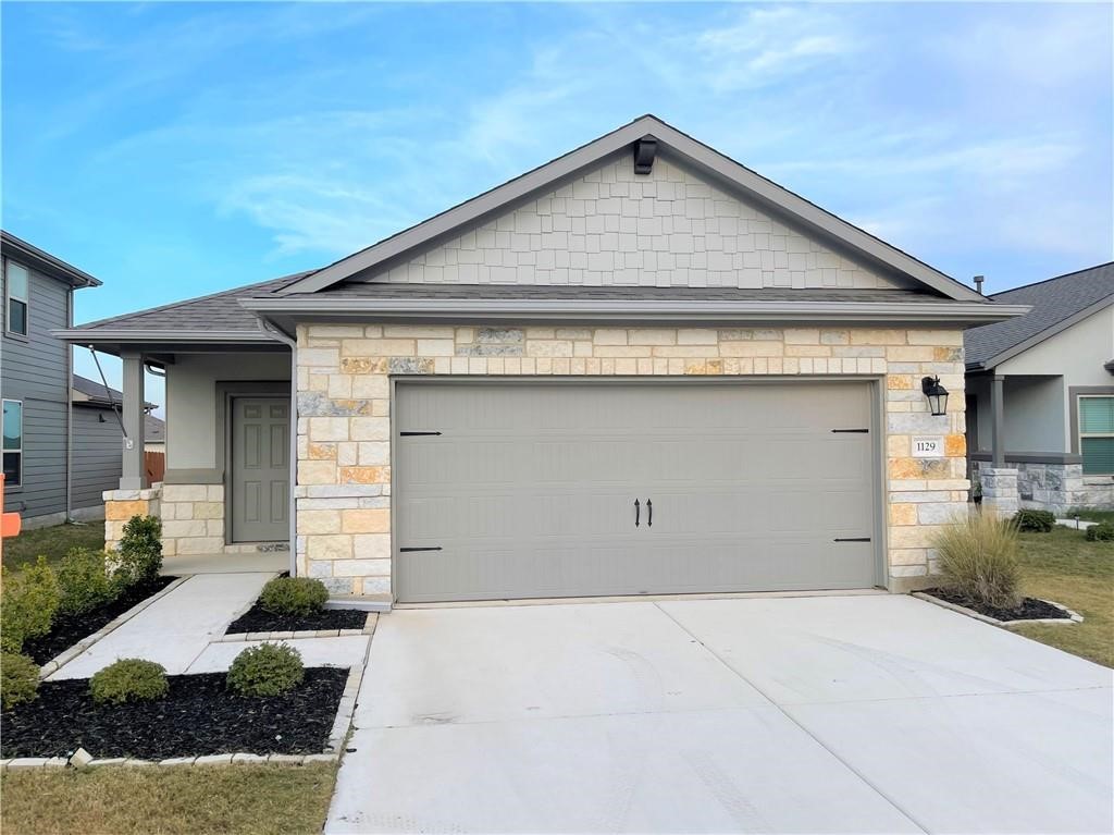 a front view of a house with garage