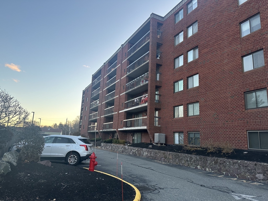 a view of building with parking space