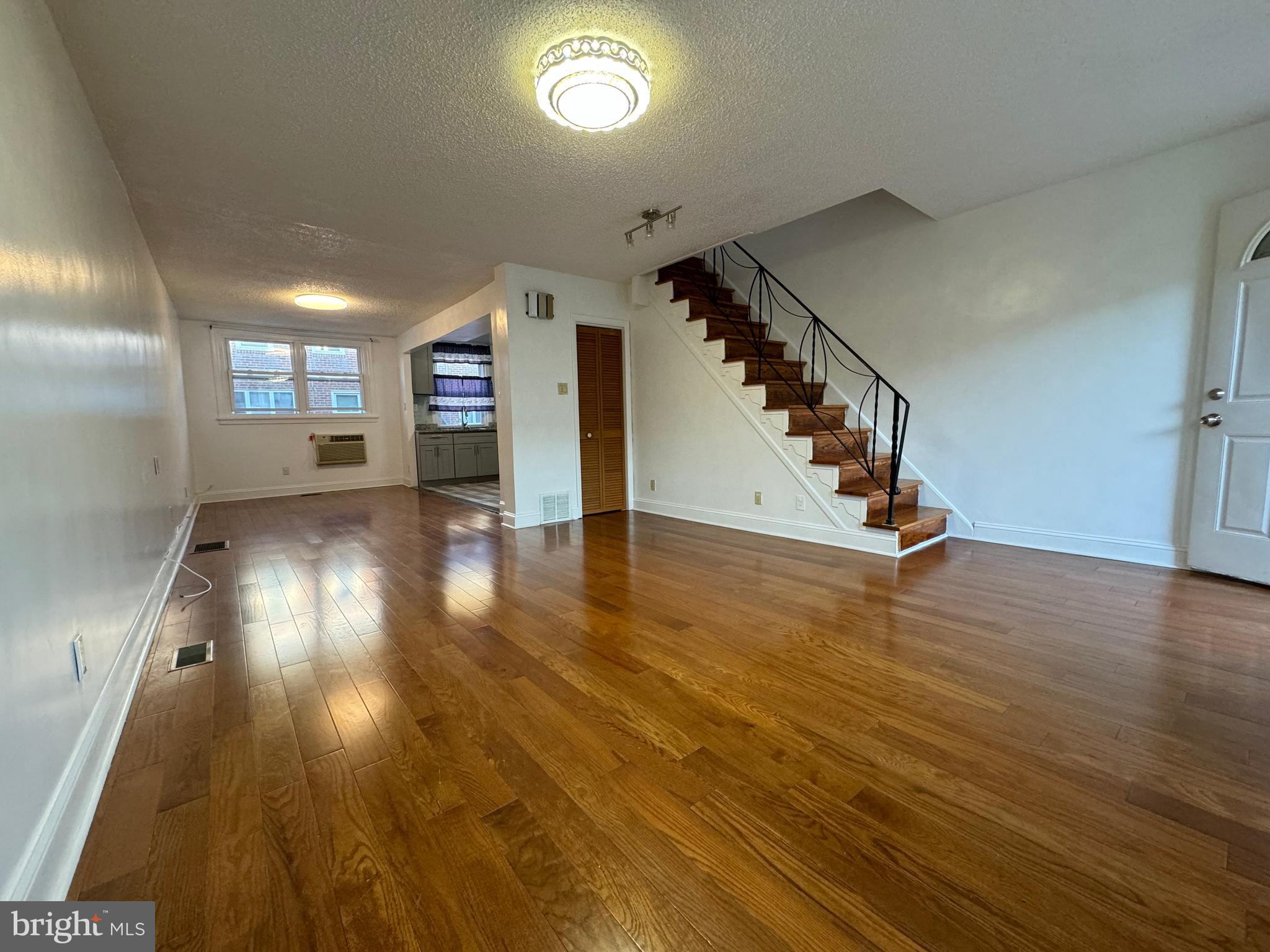 a view of entryway and hall with wooden floor