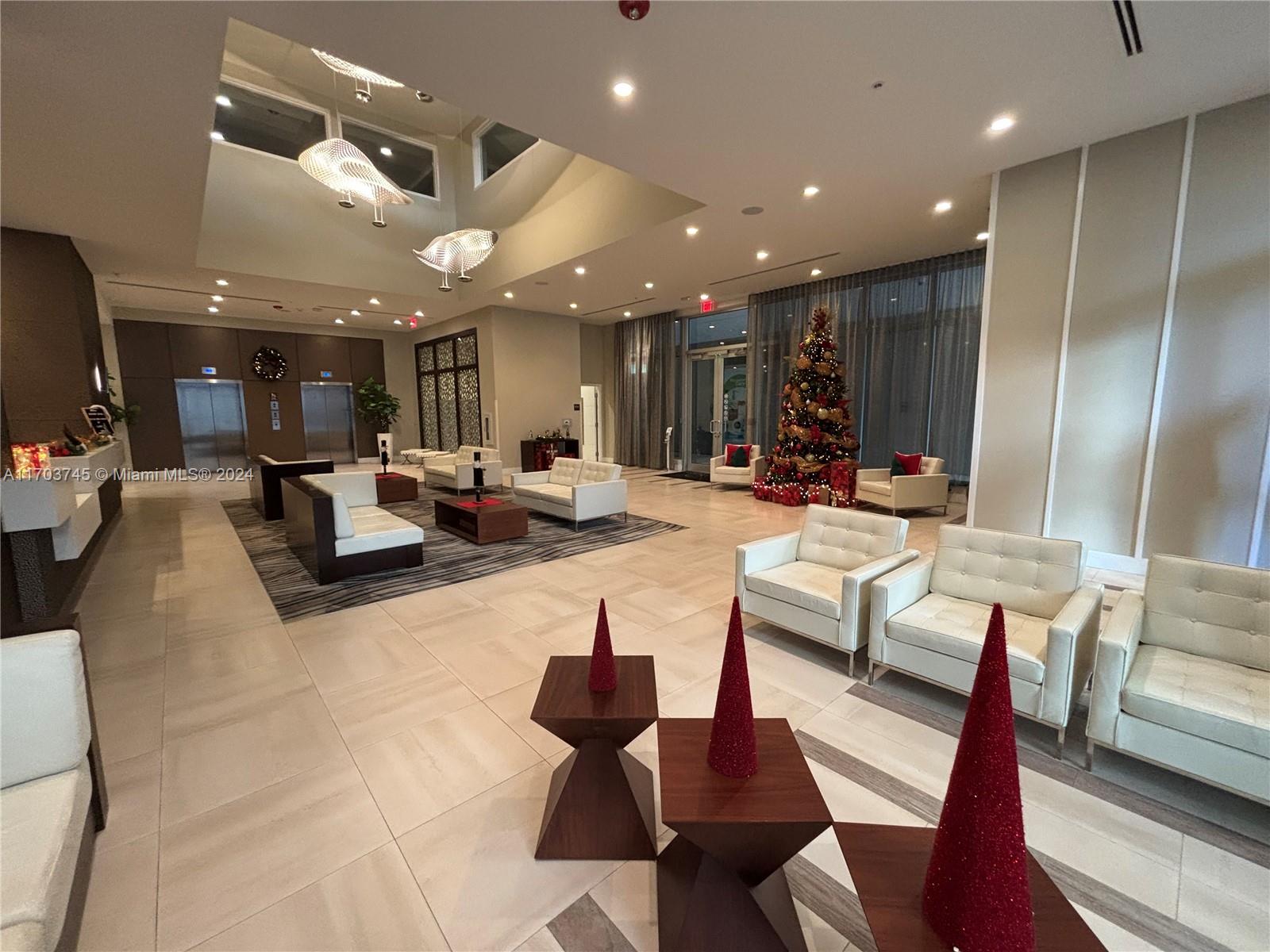 a living room with lots of furniture and view of a chandelier