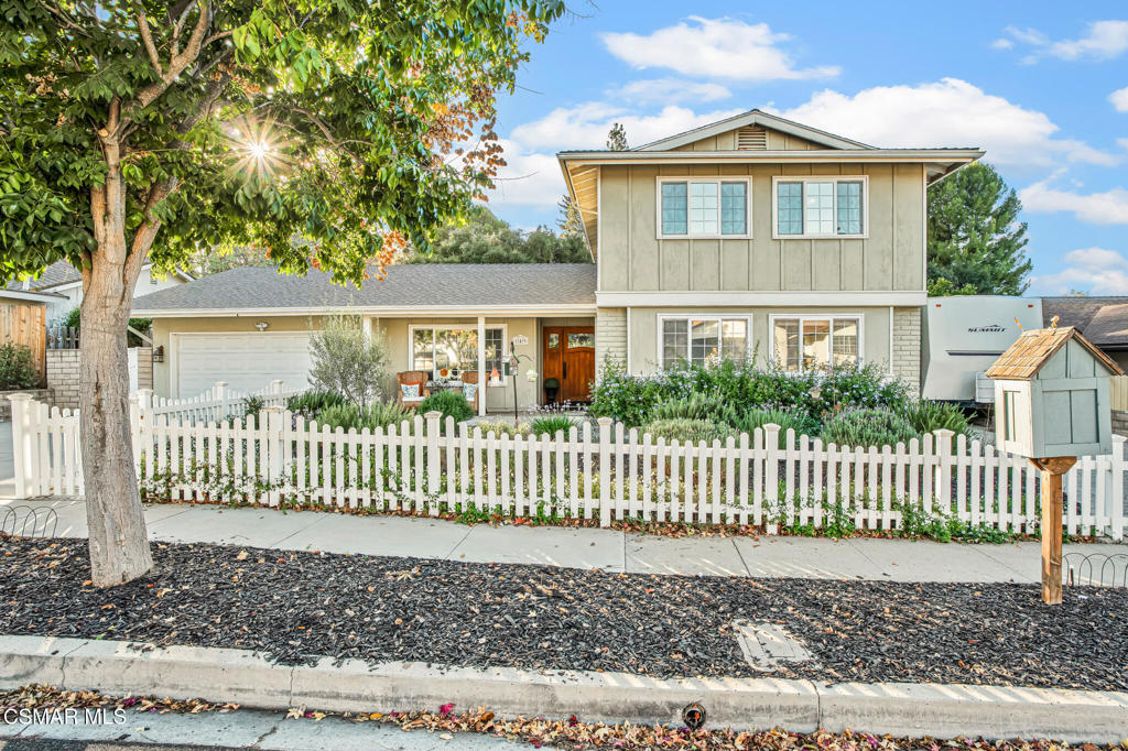 a front view of a house with a fence