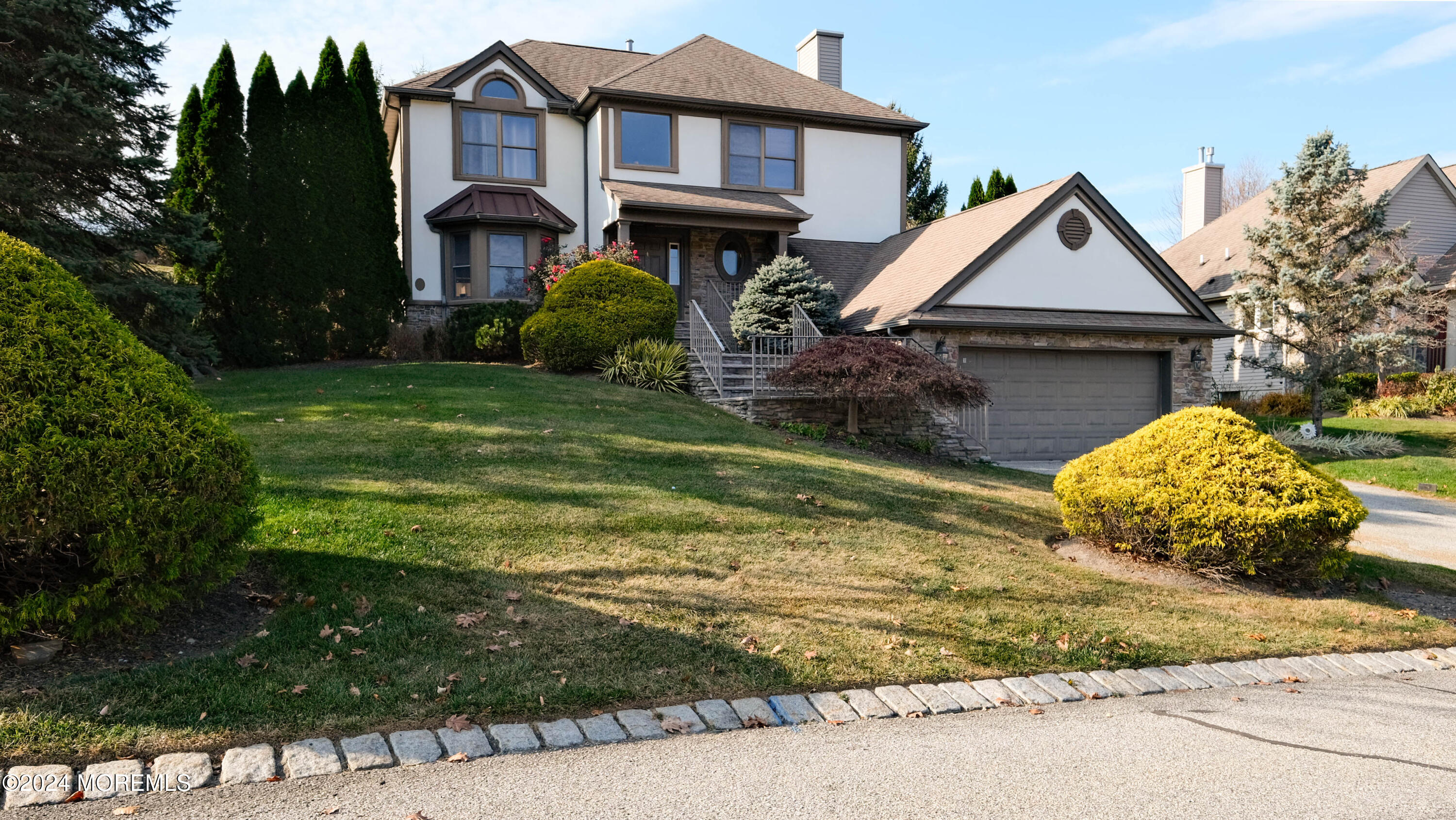 a view of a house with a yard and large tree