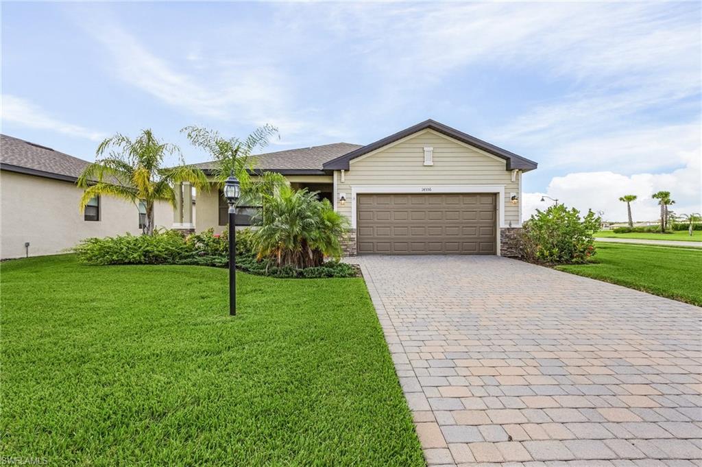 a front view of a house with a yard and garage