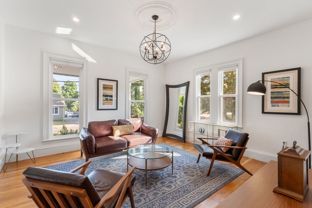 a living room with furniture a window and a table