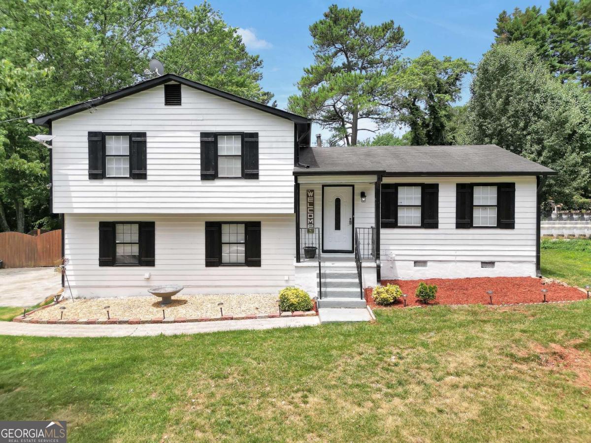 a front view of a house with a yard