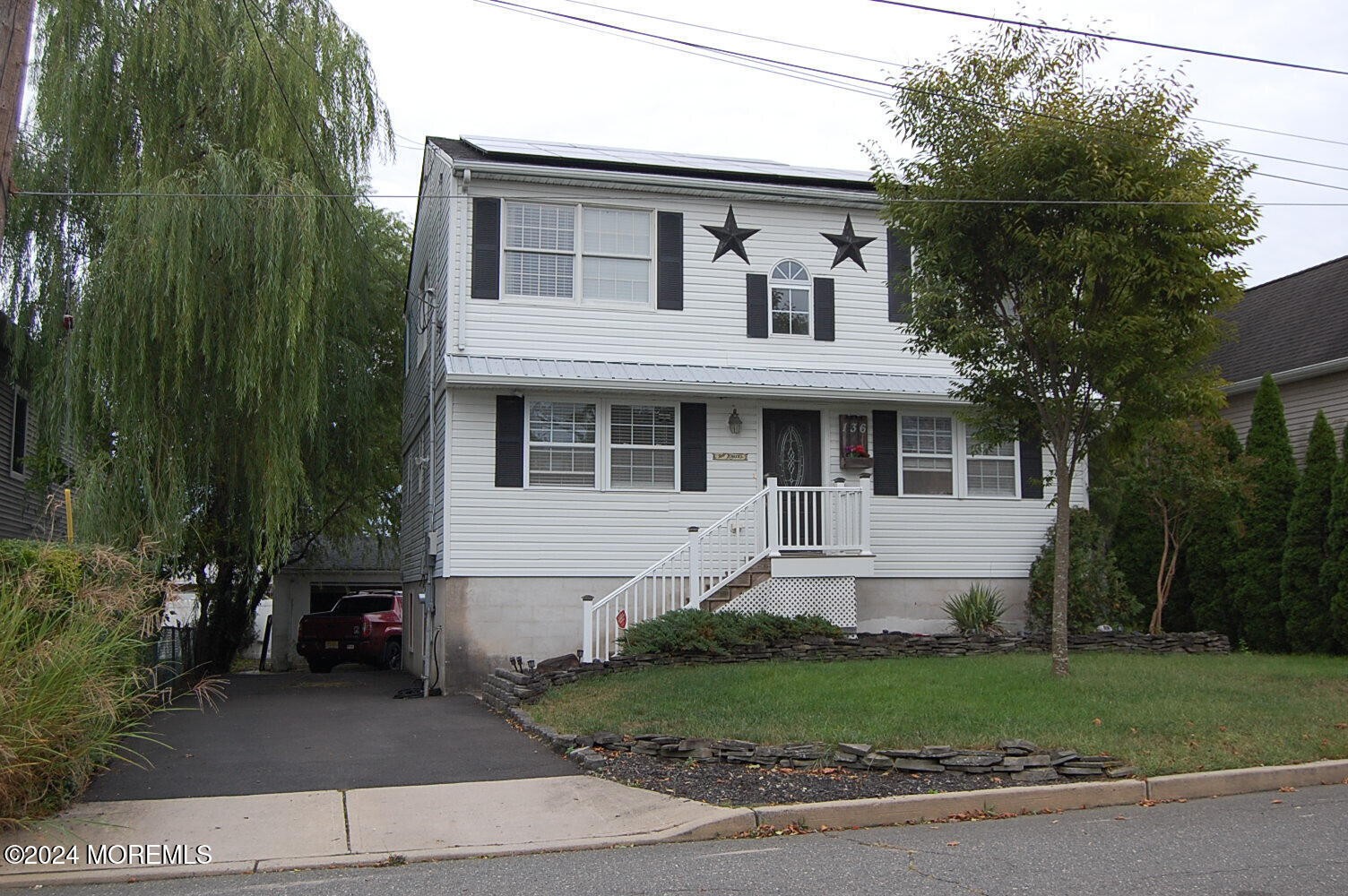 a front view of a house with a garden