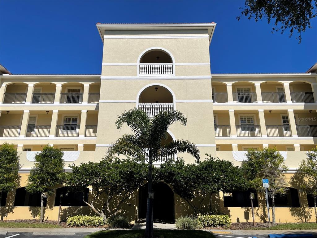 a front view of a building with a garden