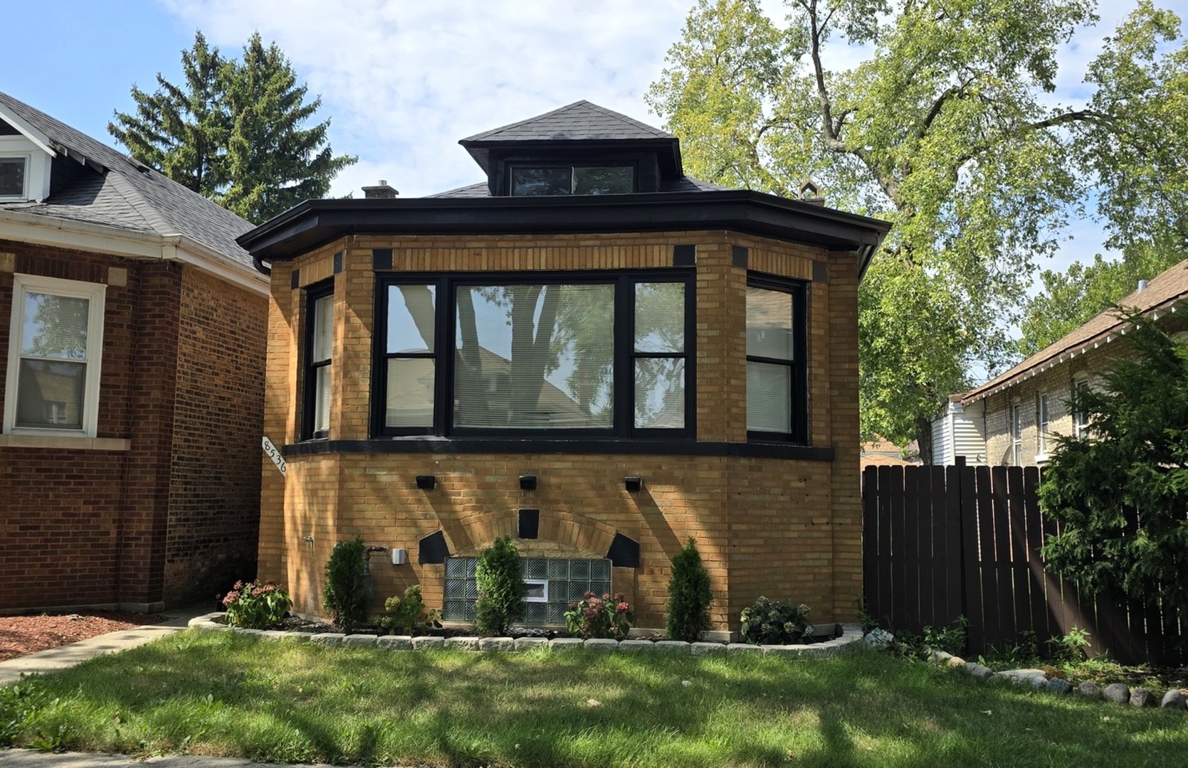 a front view of house with a garden