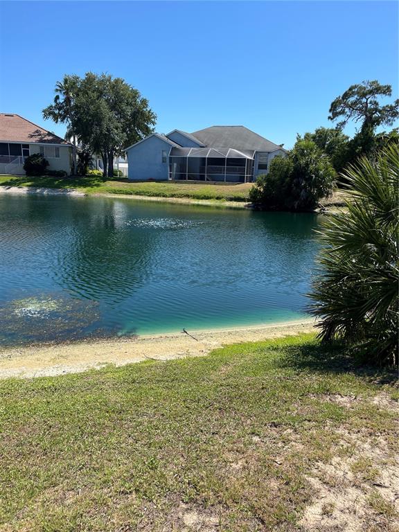 a view of a lake with a house in the background